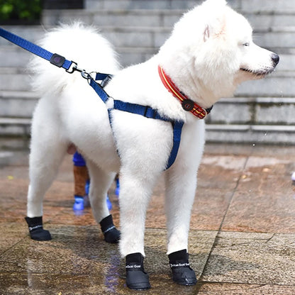 A fluffy white dog wearing waterproof dog boots (Anti-Slip Rain Shoes) while standing on a wet surface.