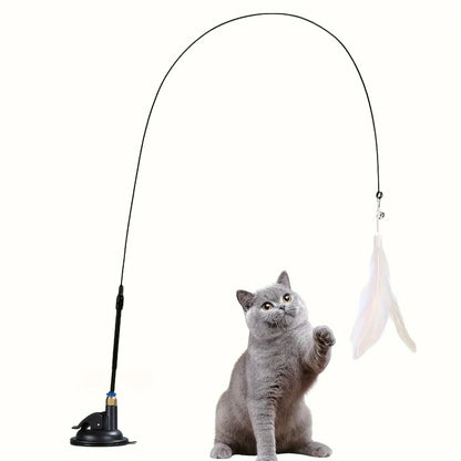 Cat Teaser Toy with feather and base, attracting a playful grey cat.